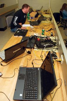 Eric Kinnard, President of AITP, completes repairs on computers brought into West Allis Campus.