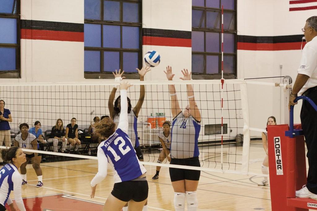 Teamwork.  #13, Sarah Schmadi and #2, Raven Steven work together to block an attempted spike by Madison College opponent. Stromers play home games at Alverno College.