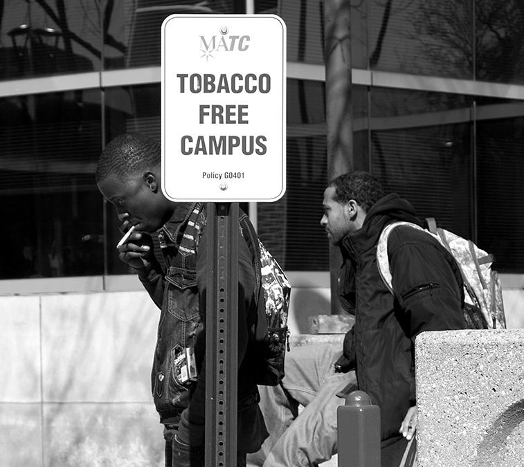With only a sign standing guard, students continue to light up and ignore the campuswide ban on tobacco at the downtown Milwaukee Area Technical College campus.  The eight-month-old policy, put into effect November 1, 2012, has had little to no impact on student smokers.