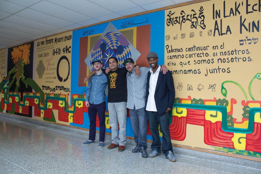 Students (left to right) Zachariah Gross, Liberal Arts; Diego Heredia, Bio-medical Research graduate and creator of mural; Sergio Torres, Business; and Devon White, Culinary Arts; stand in front of the mural located outside the third floor foreign language lab, Sept. 23.