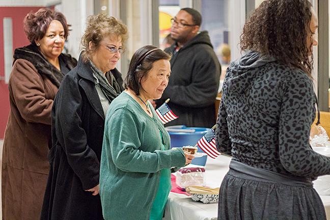 On Veterans Day, student government members hand out cake and flags to honor veterans at the West Allis Campus.
