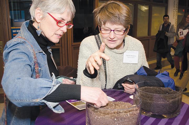 Martha Davis Kipcak (L), from the Milwaukee Food Council and Sandra Raduenz (R), of Pinehold Gardens examine different soil types on display during the eighth Annual Wisconsin Local Food Summit on Friday, Jan. 31 and Saturday, Feb. 1 at the Downtown Milwaukee campus.