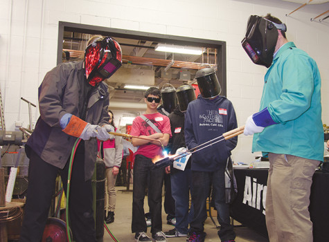Watch this, no hands. Karen Gilgenbach (left) and Adam Forstner (right) from Airgas, wow onlookers by making a grilled cheese sandwich with a welding torch at MATC Oak Creek Campus, Heavy Metal Tour on March 18.