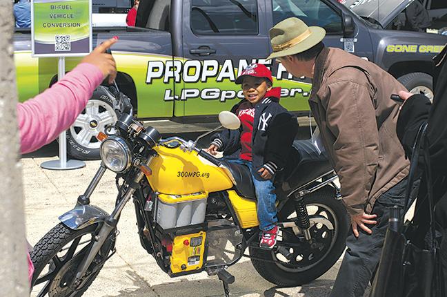 A young boy is taught a little bit about electrical powered motorcycles at MATC’s downtown Milwaukee campus during the Green Vehicles event. 