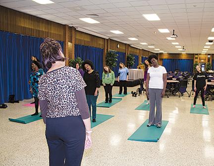 Students using meditation and stress relief techniques.