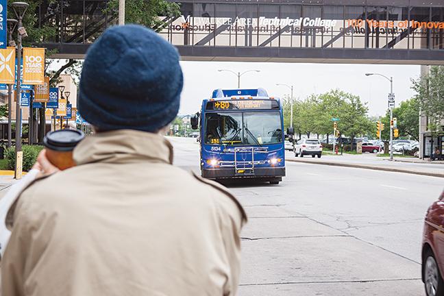 The 80 bus approaches the bus stop in front of MATC on 6th and State Street to pick up passengers.