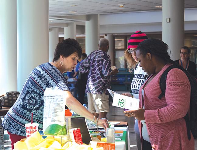 An independent consultant for Arbonne skin care products gives students information on their products based on botanical principles at the first Community Resource Fair at the Downtown Milwaukee campus.