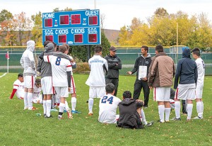 At halftime, Head Coach Jonathan Greenfield went over strategy with the team during the game on Oct. 3 against the Rock Valley Eagles. 