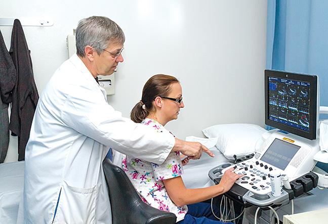 Dr. Richard Dettman, instructor for the Cardiovascular Technology program, instructs Melanie Lemke, a student in echocardiography.