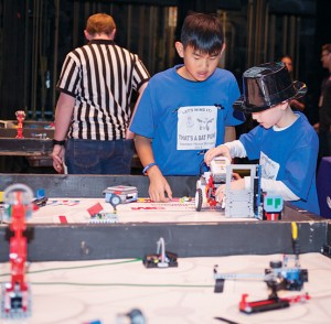 Madison Master Builders’ team members readying their robot on the course for the performance round.
