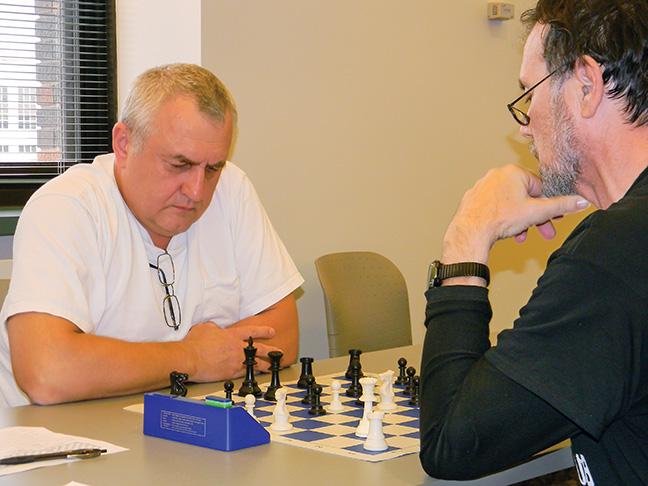 Volodymyr Opryshchenko battles Brian Spaeth, co-adviser for the Chess Club, for first prize in the chess tournament.
