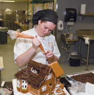 Hannah Antkowski, Baking and Pastry arts program, putting together her gingerbread house.