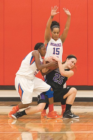 Shonnice Vaughn, guard, (#20) wrestles the ball away from a UW-Whitewater Warhawk player during the close game Dec. 8. Stormers kept their lead and won 79-70.