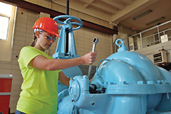 Allison Reichert gets hands-on training while learning about the water treatment operator maintenance. 