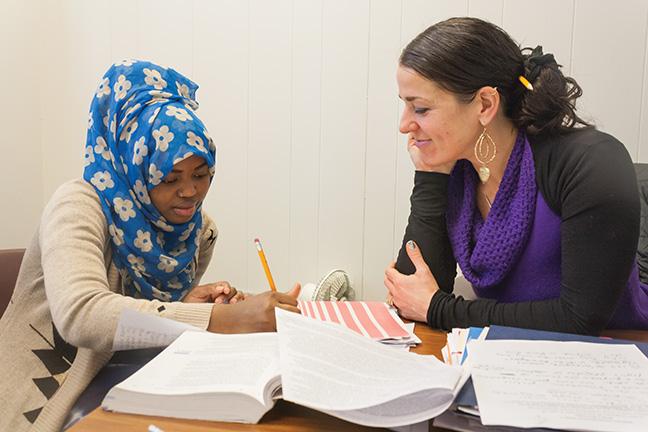 Early Childhood Education student Nimo Abdi (L) receives tutoring help from Educational Assistant Elizabeth Miller at the Office of Bilingual Education in M224 at the Downtown Milwaukee campus. 