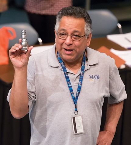 John Lopez, Student Services specialist, shows a chess piece that students will make as part of their training for the Machine Tooling program at the information session on March 10.