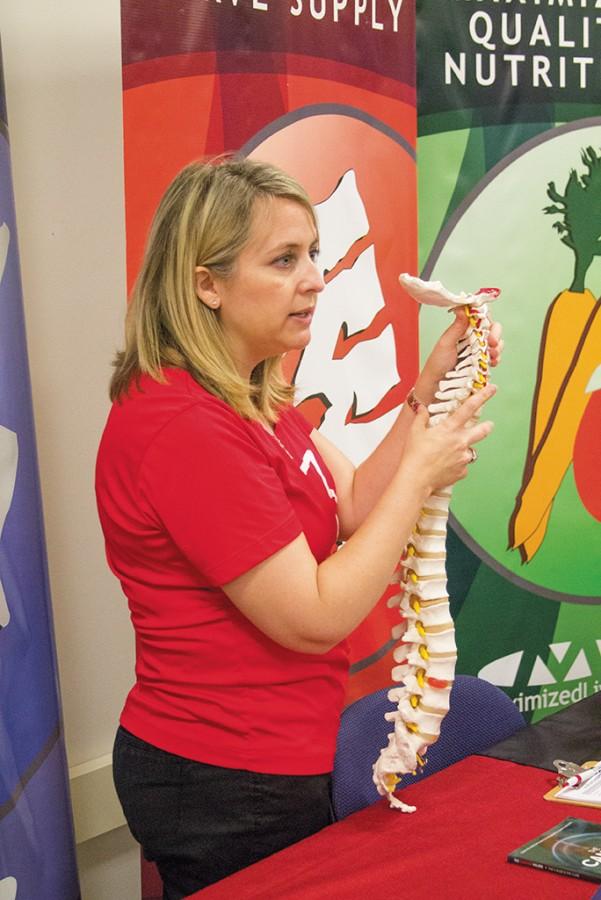 A vendor For Maximized Living Health Center, Jennifer Reasoner, points out different areas of the spine and how there can be different problems with the back. 