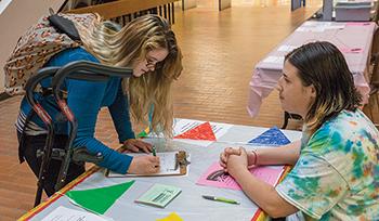 Rachel Connor, a Registered Nursing student signs up for a couple of  student organizations during the Club Recruitment at the Oak Creek campus on Sept. 8.