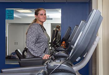 Crystal Miller, Baking and Pastry Arts student, starts her routine running on a treadmill while listening to music in the fitness center.