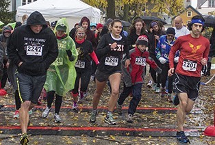 Runners brave the cold and rain as they take off for the “Day of the Dead” 5-kilometer run.