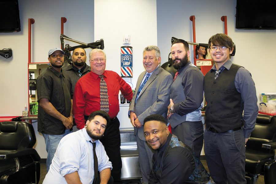 Barbering instructors Tom Ferguson (center, left) and George Gomez (center, right) took the graduating barbering students to the Milwaukee Public Museum on Oct. 4 to reflect on the rich history of the profession.