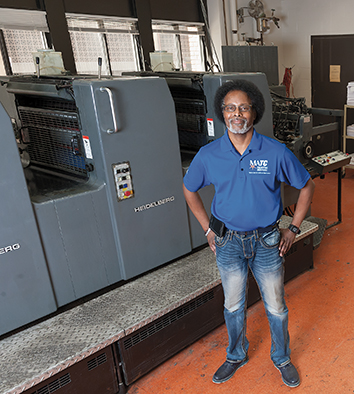 Gerald Trotter, Manager of Printing Services, poses in the printing facility.