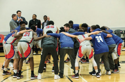 The mens basketball team gets revved up before the game starts.