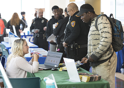 Visitors speak to MATC community partners at information tables at Pubic Safety Day on Wednesday, Feb. 28.
