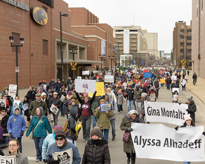 Participants walk down State Street in Milwaukee.