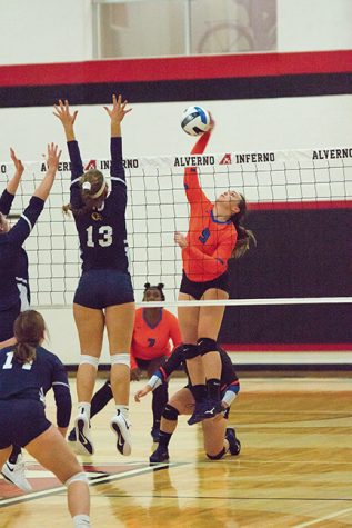 Megan Lofeffler, Stormer freshman (9) spikes over the Rock Valley defense on 
Sept. 20. Unfortunately, the Stormers lost 0-3.