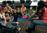 Antoinette Jackson, from Student Life, reads to children from the MATC child care center at the West Allis Campus, during story hour on Nov. 5, with children’s books from the library’s new Family Literacy Collection.
