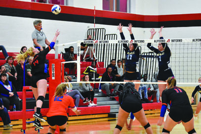 Stormers freshman Hannah Meyer (14) outwits a double block from Rock Valley
College while Zoie Nitkowski (12), captain Zoe Jordan and Sydney Carleton (11)
prepare for a dig.