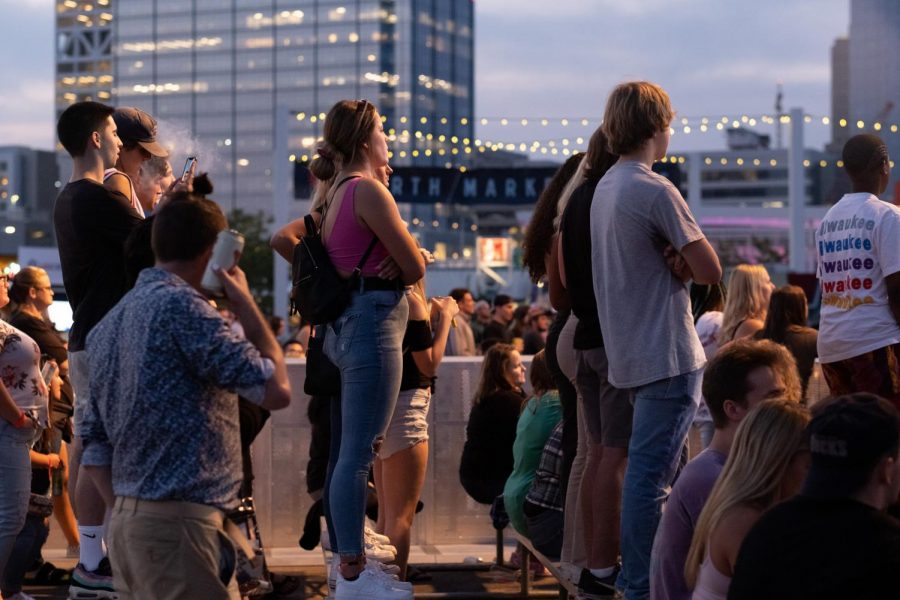 Attendees watch a performance at the US Cellular Connection Stage. As day turns into night at Summerfest, the skyline comes alive with the soft glow of stage lighting beneath the Milwaukee skyline.