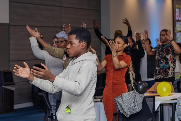 Hands are raised at the MOSAIC Black History Month banquet held on Friday, March 1, at the MATC Downtown Campus.