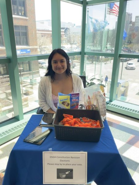 District Student Government Association (DSGA) Lt. Governor Elizabeth (Lizzy) Calixto is stationed by the Second Floor Bridge at the Downtown Campus to raise awareness of a student vote this week to amend the DSGA constitution. 