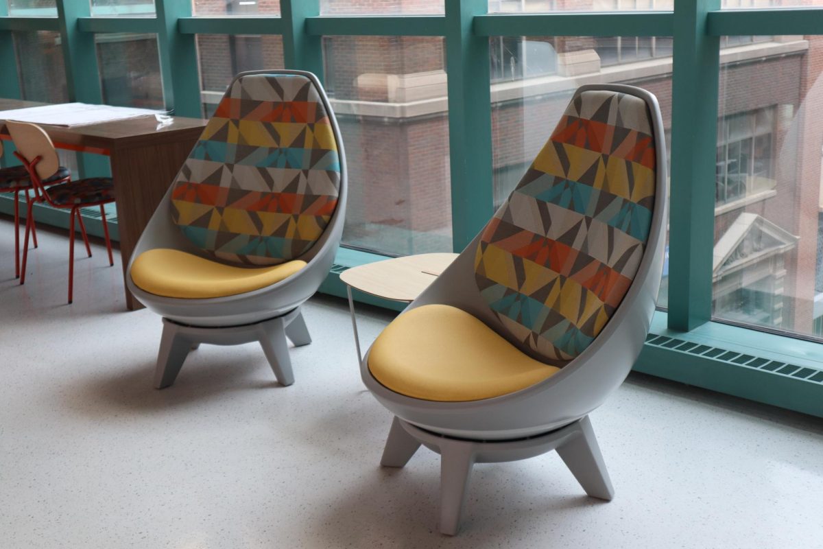A close up of two very comfortable egg-shaped chairs that swivel and tip back. They are located on the south side windows the Student Lounge and Rec Center on the third floor of the S Building. 