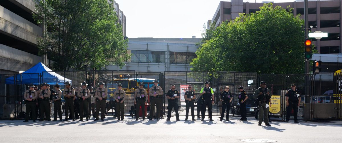 Police stand guard as protestors approach the hard perimeter of the RNC.