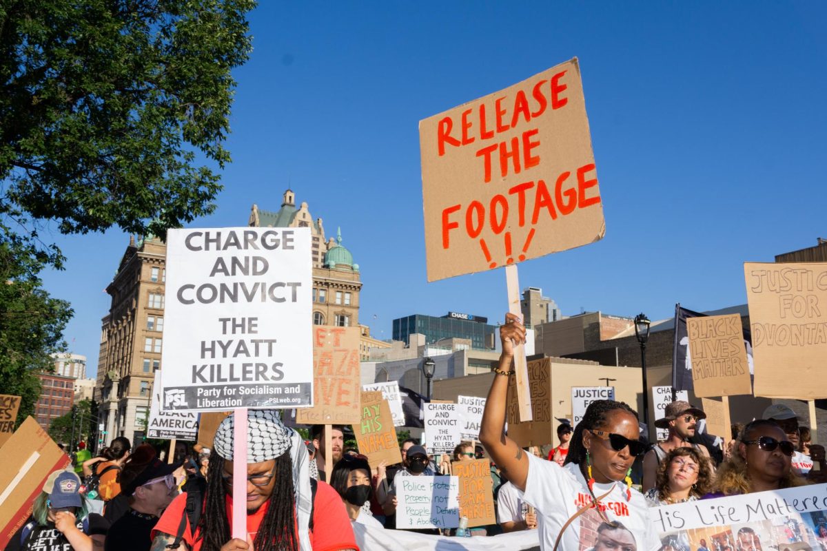 Protestors are overcome with emotion as they walk to support Samuel Sharpe Jr. "Jah" and D’Vontaye Mitchell. Sharpe was shot and killed after refusing to drop two knives while running toward another Black man. Mitchell was killed outside the Hyatt Hotel after being held down and restrained by security guards.