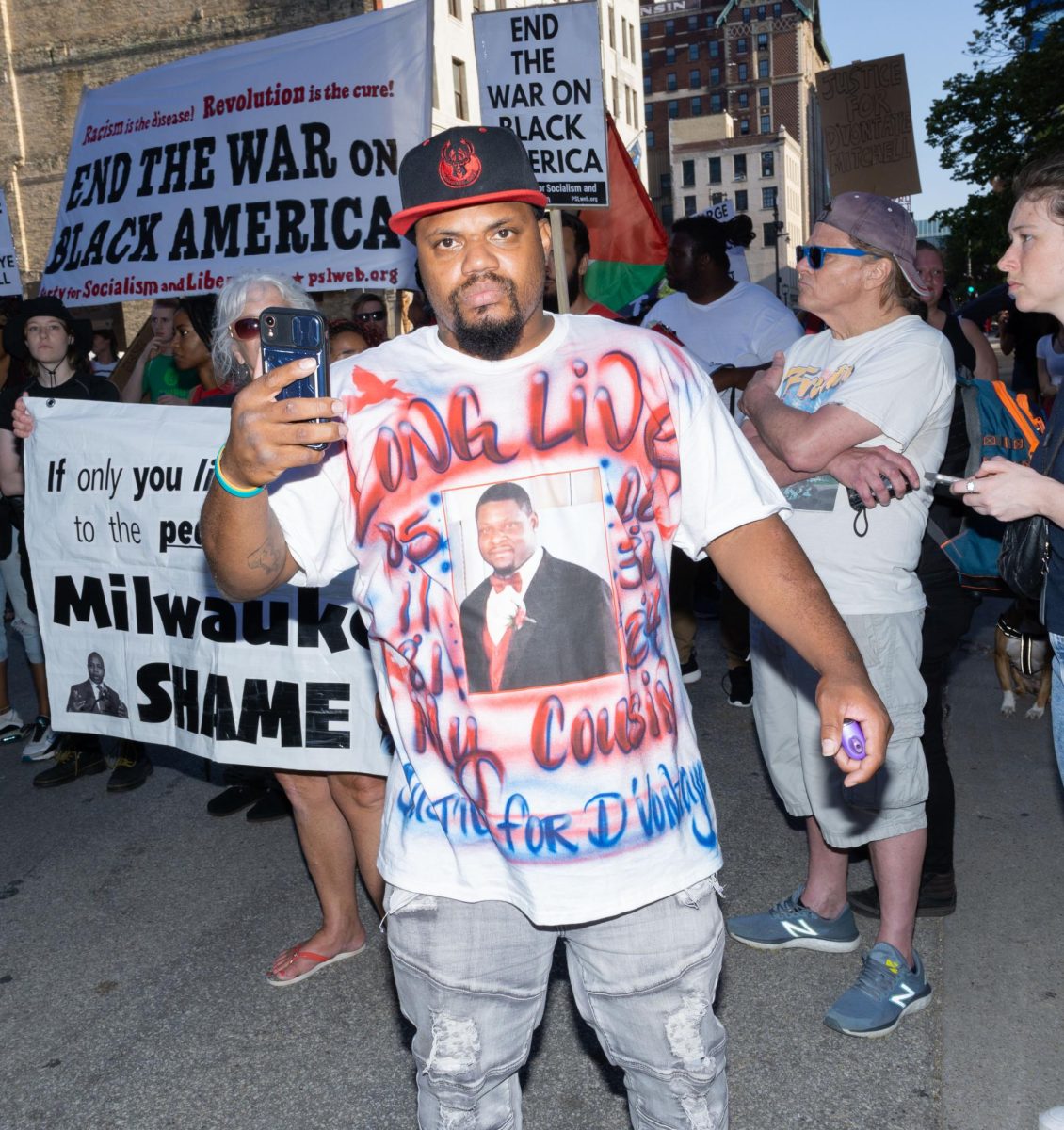 A family member of D’Vontaye Mitchell wears a shirt in his honor at a protest in Milwaukee.