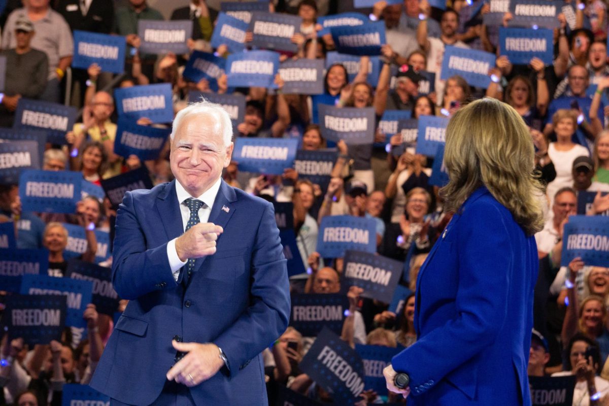 Minnesota Gov. Tim Walz points and smiles at Vice President Kamala Harris as the crowd continues to cheer for her during their rally in Milwaukee on Tuesday August 20th, 2024 at the Fiserv Forum. 