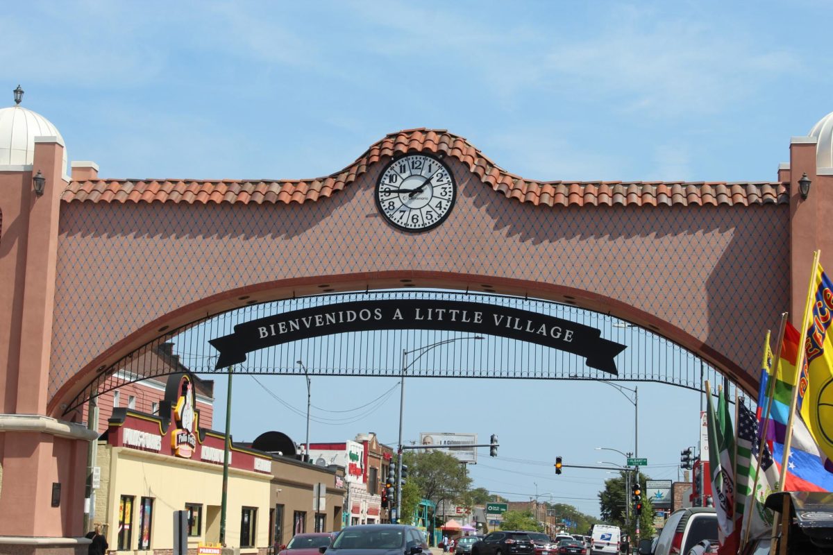 A terracotta arch over 26th Street in Chicago welcomes visitors to an authentic slice of Mexican Life in one of the busiest shopping districts in the city, Little Village. Food, art, and Mexican clothing give visitors a glimpse into the culture.