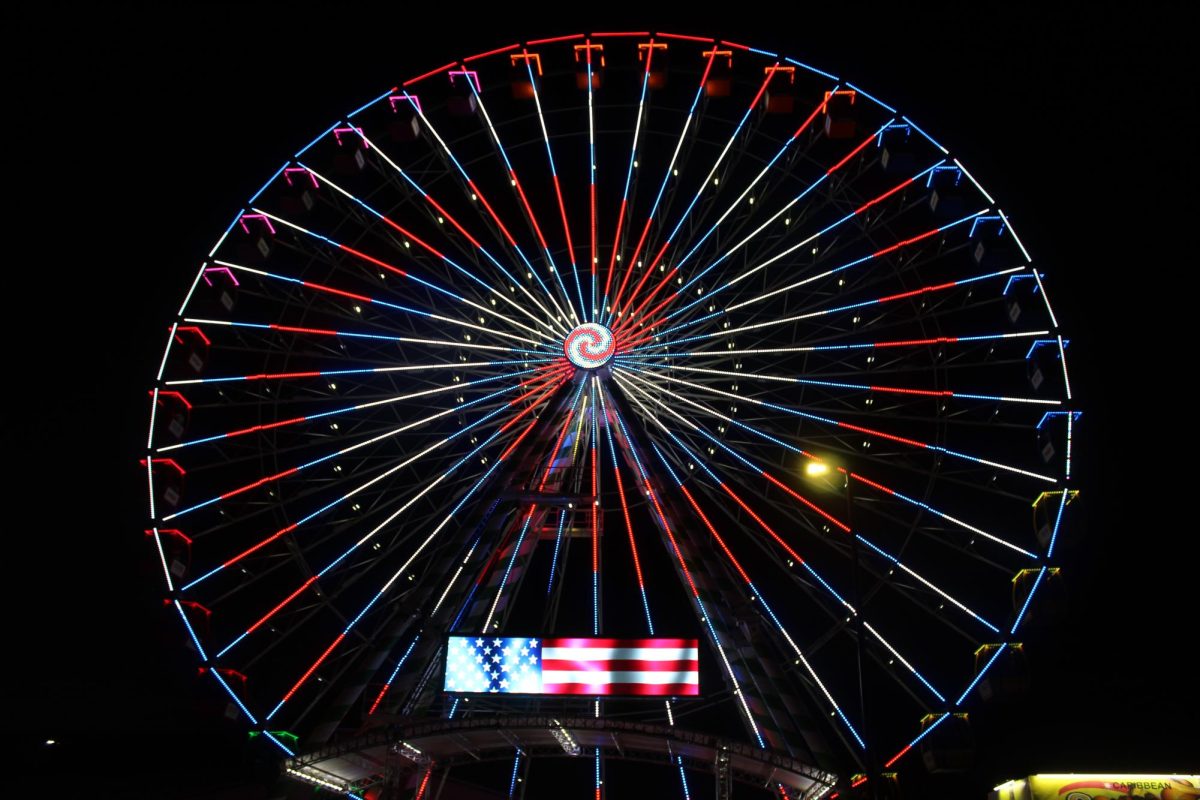 With the Olympics underway in Paris, the Ferris Wheel at the Wisconsin State Fair displays the patriotic red, white and blue colors of the U.S.A.