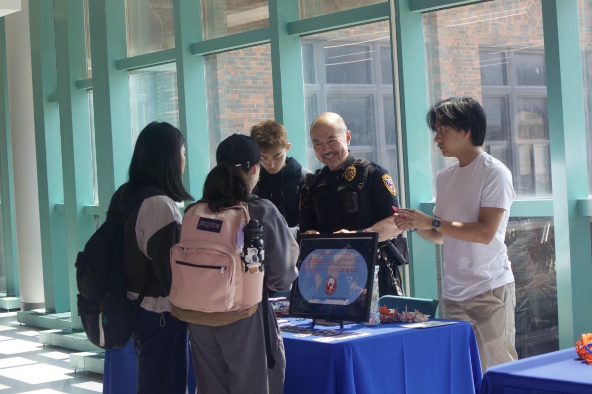 Department of Public Safety Manager Gary Morimoto enjoys showing students how to make origami cranes at the Asian Student Association table during the first Wild Out Wednesday event in the new Student Lounge at the Downtown Campus.