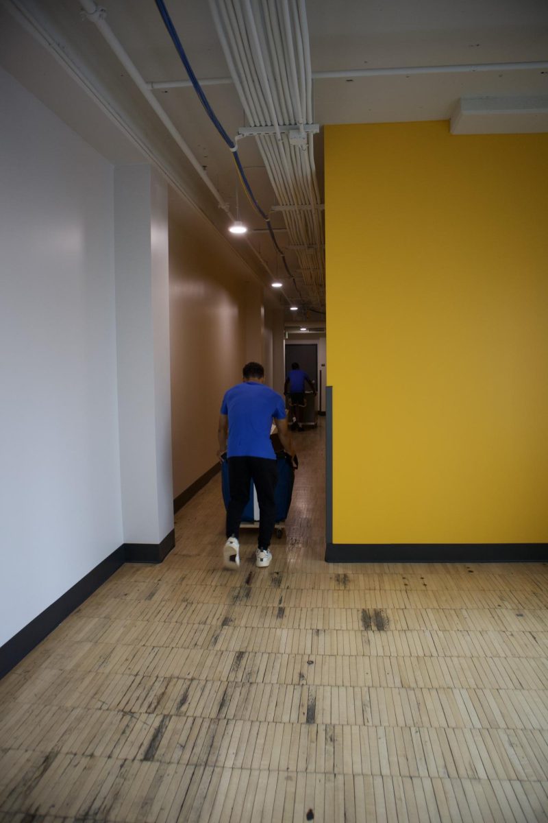 Students moving boxes through Westown Green hallways on move-in day