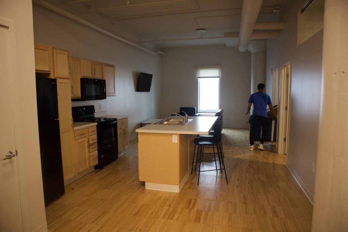 Student moving things into rooms in Westown Green apartment on move-in day