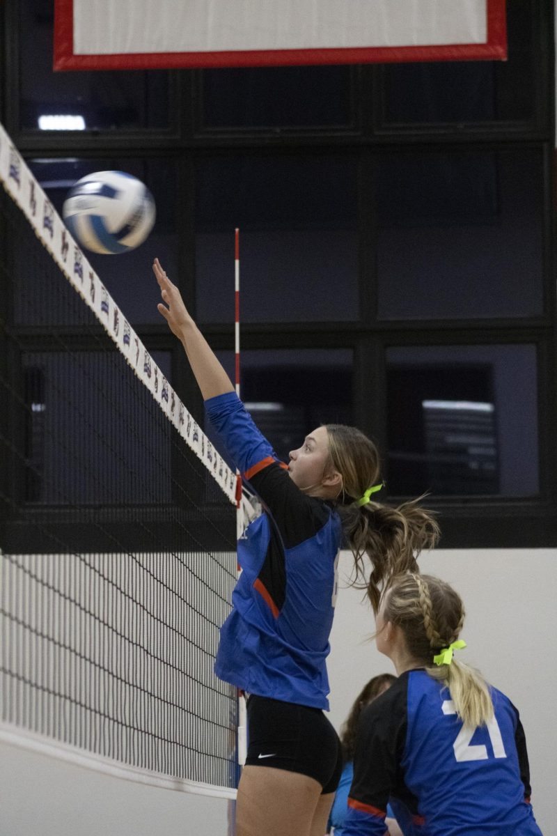 #21 Freshman Pin Kendall Revolinsk blocking at the net 