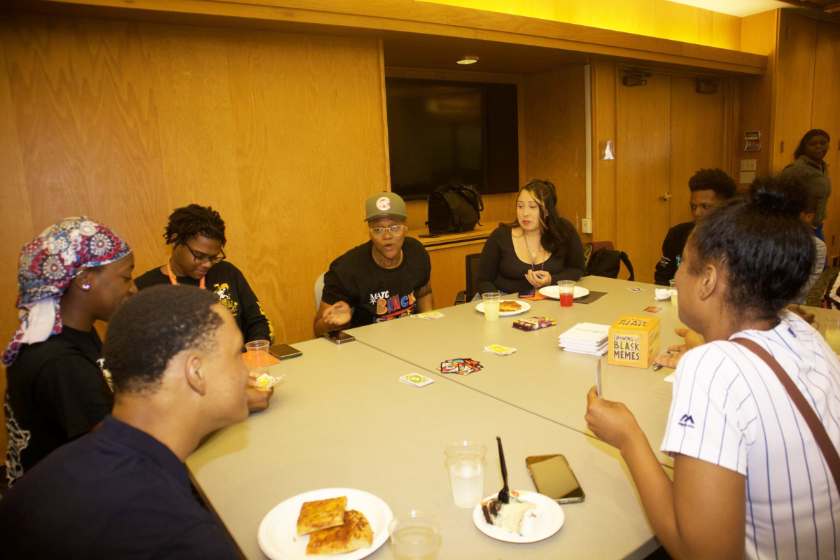 Students enjoy pizza and connecting with peers at a Black Student Union (BSU) Kickback event.