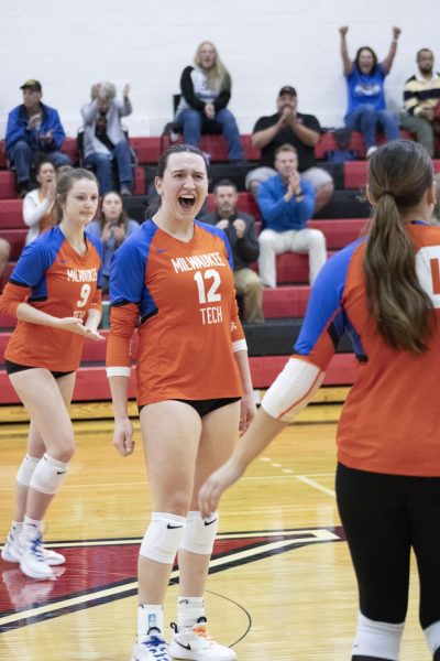 Sophomore Outside Hitter/Middle Blocker #12 Paige Siehr celebrating after scoring a point against Harper College on October 10, 2024.