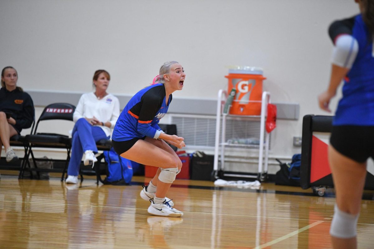 Outside Hitter Sam Seihr brings her energy by cheering on the court.