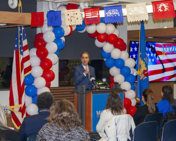 MATC President Dr. Anthony Cruz speaks to newly naturalized U.S. citizens, their family and friends during a celebration at Walker's Square.